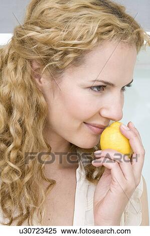 Woman smelling on lemon View Large Photo Image Stock Photography - Woman smelling on lemon. Fotosearch