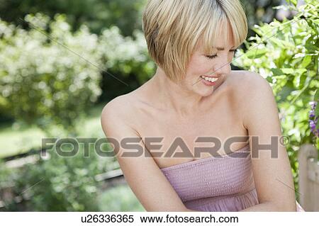Woman smiling in garden View Large Photo Image Stock Photography - Woman smiling in garden. Fotosearch