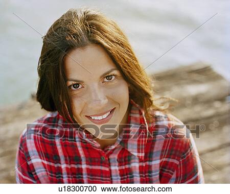 Stock Image - Woman smiling with wind in her hair. Fotosearch