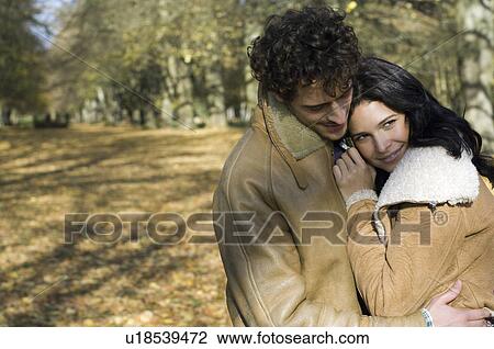 Stock Image - Woman snuggling against man. Fotosearch