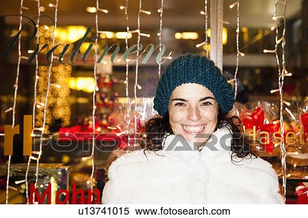 Stock Photography - Woman standing in front of shopwindow. Fotosearch