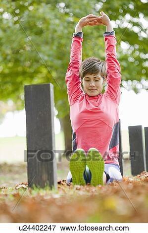 Woman stretching in park before workout View Large Photo Image Stock Photo - Woman stretching in park before workout. Fotosearch