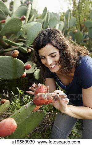Woman touching cactus View Large Photo Image Stock Photo - Woman touching cactus. Fotosearch