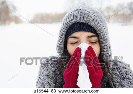 Stock Image - Woman using tissue. Fotosearch