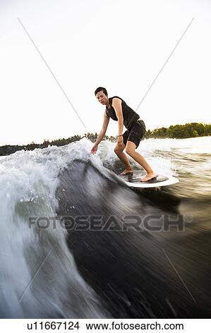 Picture - Woman wakesurfing. Fotosearch