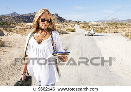 Woman walking away from motorbike View Large Photo Image Stock Photograph - Woman walking away from motorbike. Fotosearch