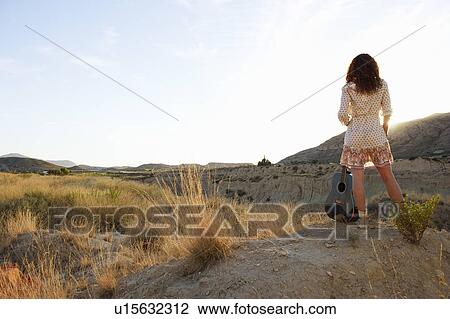 Woman watching the sun set View Large Photo Image Stock Image - Woman watching the sun set. Fotosearch