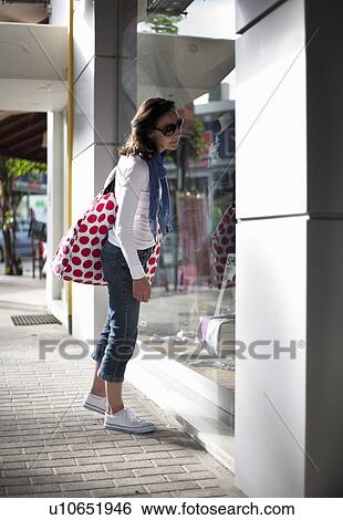 Stock Photograph - Woman window shopping. Fotosearch