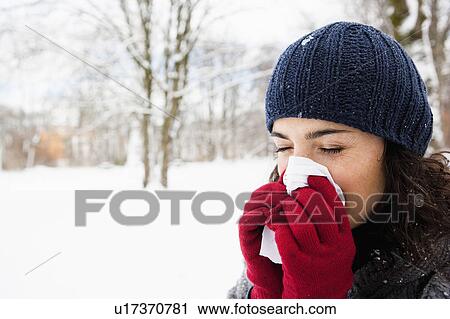 Woman wiping her nose View Large Photo Image Stock Image - Woman wiping her nose. Fotosearch
