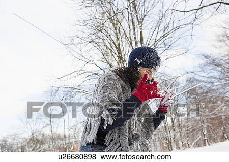 Woman wiping snow out of her face View Large Photo Image Stock Photo - Woman wiping snow out of her face. Fotosearch