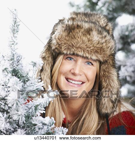 Woman with a faux-fur hat, smiling View Large Photo Image Stock Image - Woman with a faux-fur hat, smiling. Fotosearch