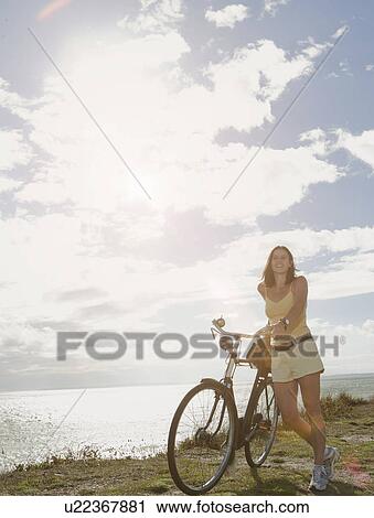 Stock Image - Woman with bicycle. Fotosearch