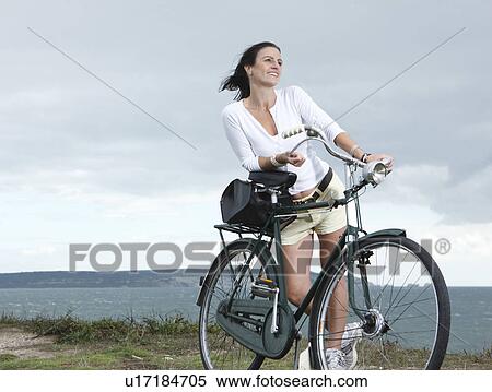 Stock Photography - Woman with bicycle. Fotosearch