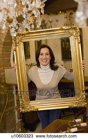 Woman with picture frame View Large Photo Image Stock Image - Woman with picture frame. Fotosearch