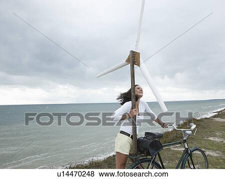 Woman with wind turbine View Large Photo Image Stock Photo - Woman with wind turbine. Fotosearch