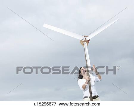 Stock Photo - Woman with wind turbine. Fotosearch