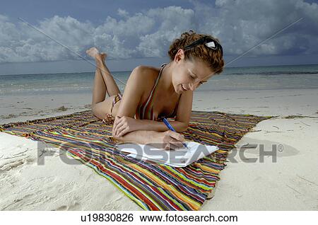 Woman writing on beach View Large Photo Image Stock Photograph - Woman writing on beach. Fotosearch