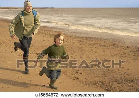 Woman, young boy running on beach. Fall View Large Photo Image Stock Image - Woman, young boy running on beach. Fall. Fotosearch