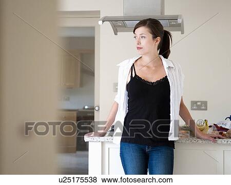 Stock Photo - Women deep in thought in kitchen. Fotosearch