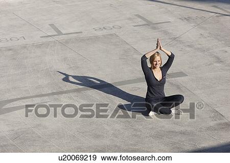 Women doing yoga on rooftop View Large Photo Image Stock Photo - Women doing yoga on rooftop. Fotosearch