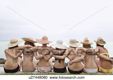Women in bikinis hugging View Large Photo Image Stock Image - Women in bikinis hugging. Fotosearch