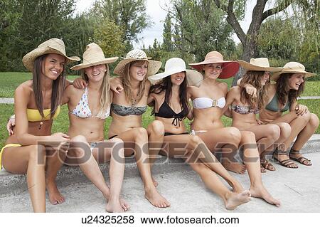 Women in bikinis sit together View Large Photo Image Stock Photo - Women in bikinis sit together. Fotosearch