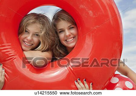 Stock Image - Women looking through buoyancy ring. Fotosearch