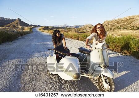 Stock Photo - Women pushing motorbike and sidecar. Fotosearch