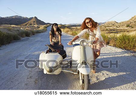 Stock Photography - Women pushing motorbike and sidecar. Fotosearch