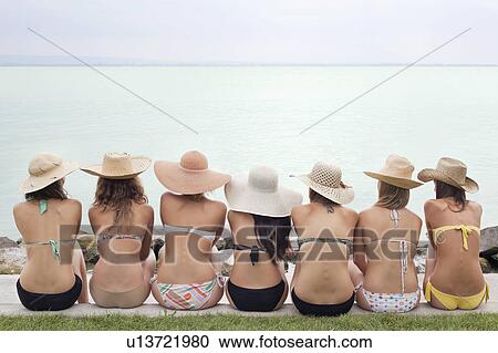 Women sitting by lake side in bikini View Large Photo Image Stock Image - Women sitting by lake side in bikini. Fotosearch