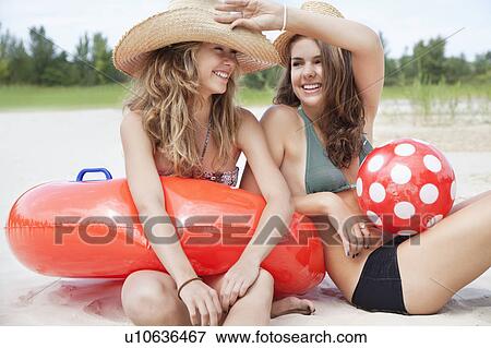 Women sitting on a beach relaxing View Large Photo Image Stock Photo - Women sitting on a beach relaxing. Fotosearch