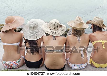 Women sitting together by edge of lake View Large Photo Image Stock Photo - Women sitting together by edge of lake. Fotosearch