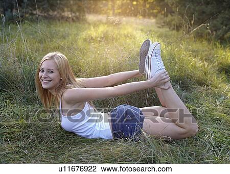 Stock Image - Women stretching in nature. Fotosearch