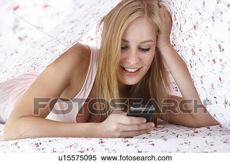 Women under blanket with cellphone View Large Photo Image Stock Photography - Women under blanket with cellphone. Fotosearch