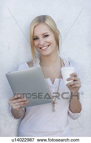 Stock Photo - Women with coffee and ipad. Fotosearch