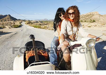Stock Image - Women with motorbike and sidecar. Fotosearch
