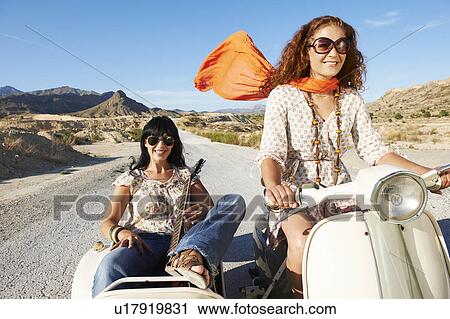 Stock Image - Women with motorbike and sidecar. Fotosearch
