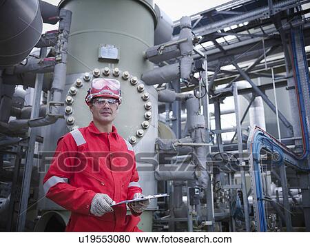 Stock Image - Worker at underground gas storage plant. Fotosearch