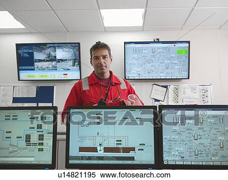Stock Photography - Worker in control room of gas plant. Fotosearch