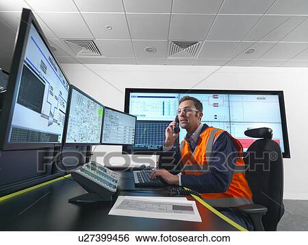 Worker in control room with screens View Large Photo Image Stock Photograph - Worker in control room with screens. Fotosearch