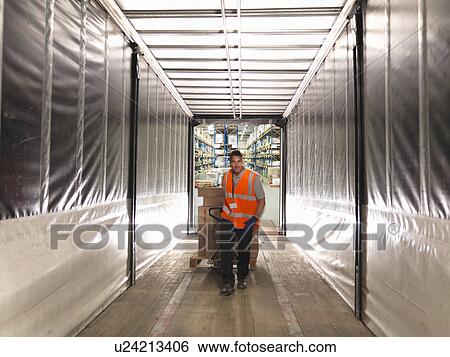 Stock Photograph - Worker loads truck with pallet truck. Fotosearch