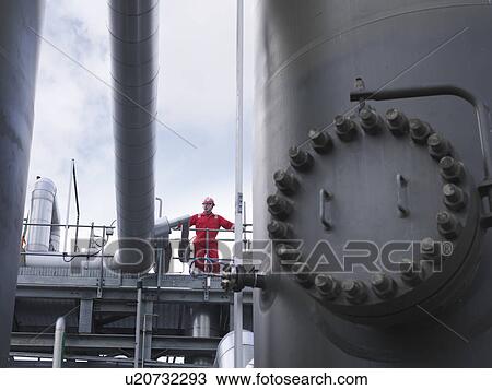 Stock Image - Worker on underground gas storage plant. Fotosearch