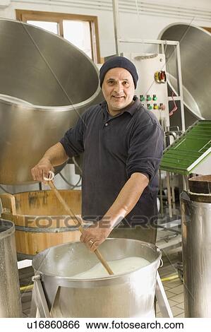 Stock Photograph - Worker producing bison mozzarella. Fotosearch