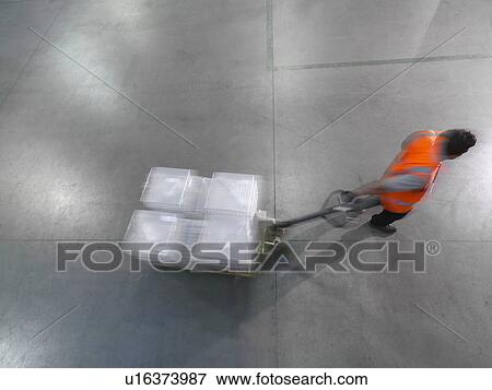 Worker pulls pallet truck View Large Photo Image Stock Photo - Worker pulls pallet truck. Fotosearch
