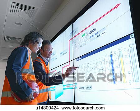 Workers in control room with screen View Large Photo Image Picture - Workers in control room with screen. Fotosearch