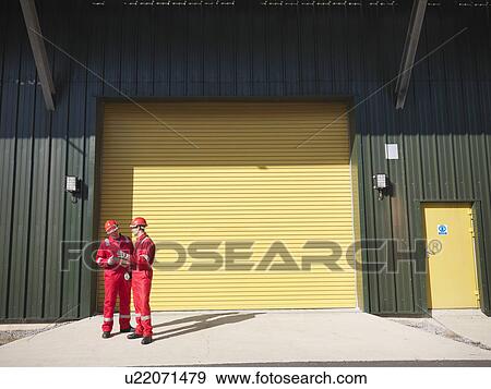 Workers in front of industrial plant View Large Photo Image Stock Photo - Workers in front of industrial plant. Fotosearch