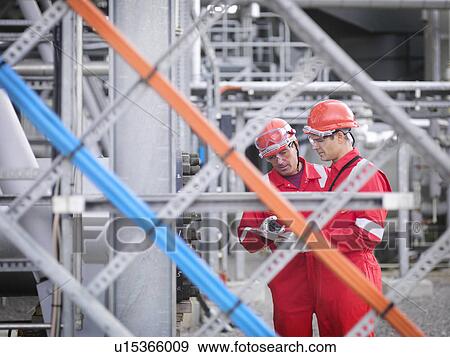 Stock Photo - Workers inspect gas storage plant. Fotosearch