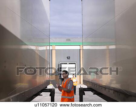 Workers inspecting load View Large Photo Image Stock Image - Workers inspecting load. Fotosearch