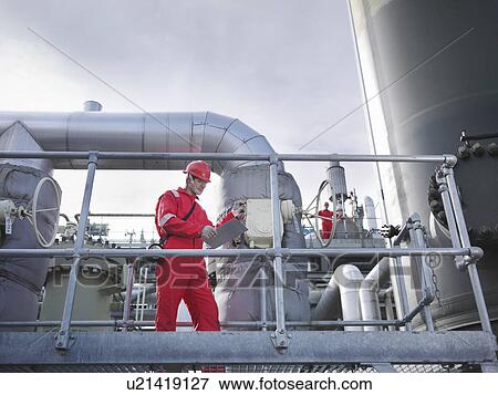 Stock Photo - Workers on underground gas storage plant. Fotosearch