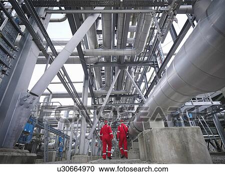 Workers walk through an underground gas View Large Photo Image Stock Image - Workers walk through an underground gas. Fotosearch